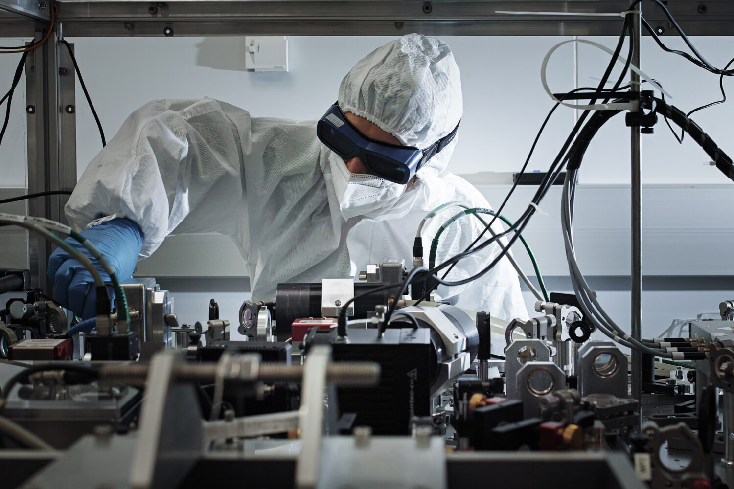 An image shows one of the researchers of the Virgo gravitational wave detector working on an optical bench. Credits: Marco Pinarelli