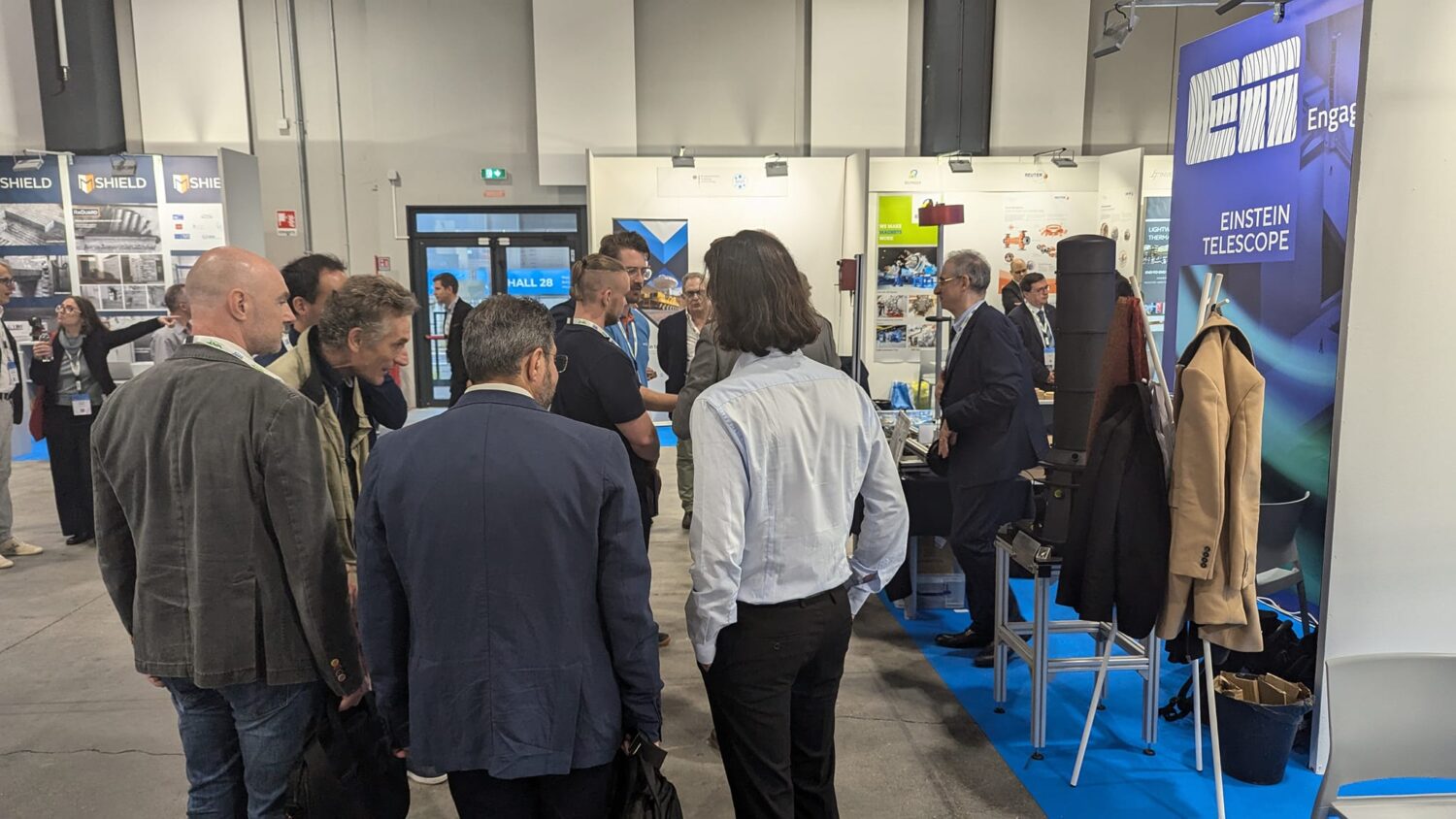 The photo shows a group of people experiencing the BSBF meeting in Trieste 2024 and chatting.