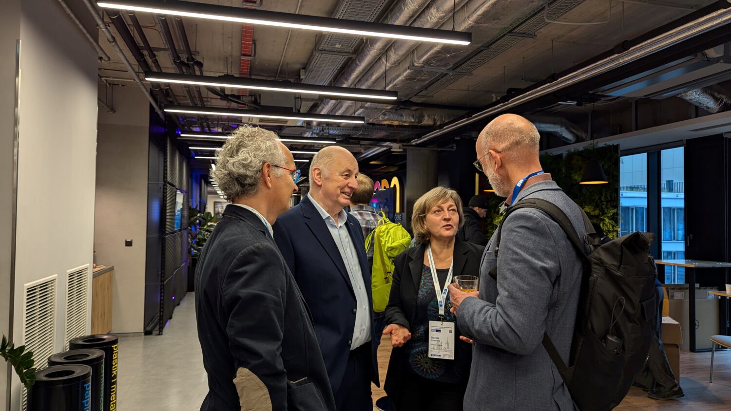 The photo shows people chatting during the ET annual meeting in Warsaw 2024.