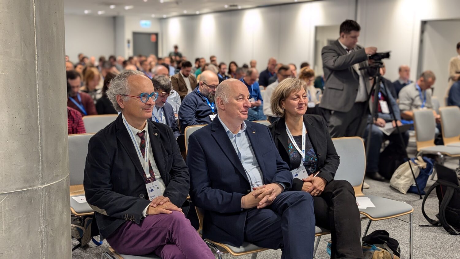 The photo shows a group of people listening to a lecture during the ET annual meeting in Warsaw 2024.