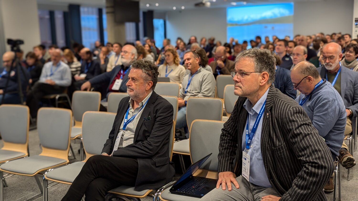 The photo shows a group of people listening to a lecture during the ET annual meeting in Warsaw 2024.
