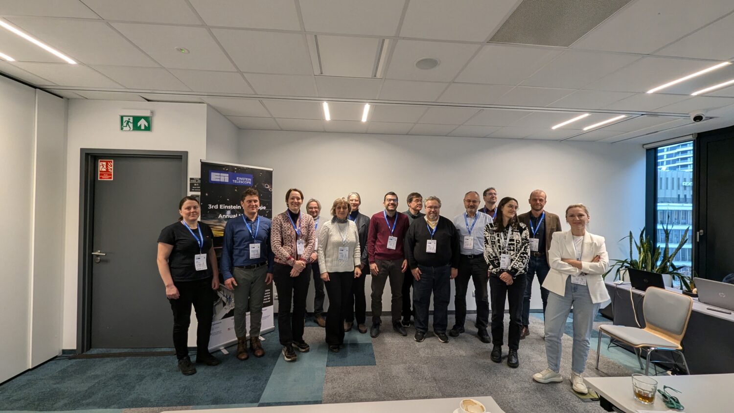 The photo shows a group of fourteen people posing for a picture during the ET annual meeting in Warsaw 2024.